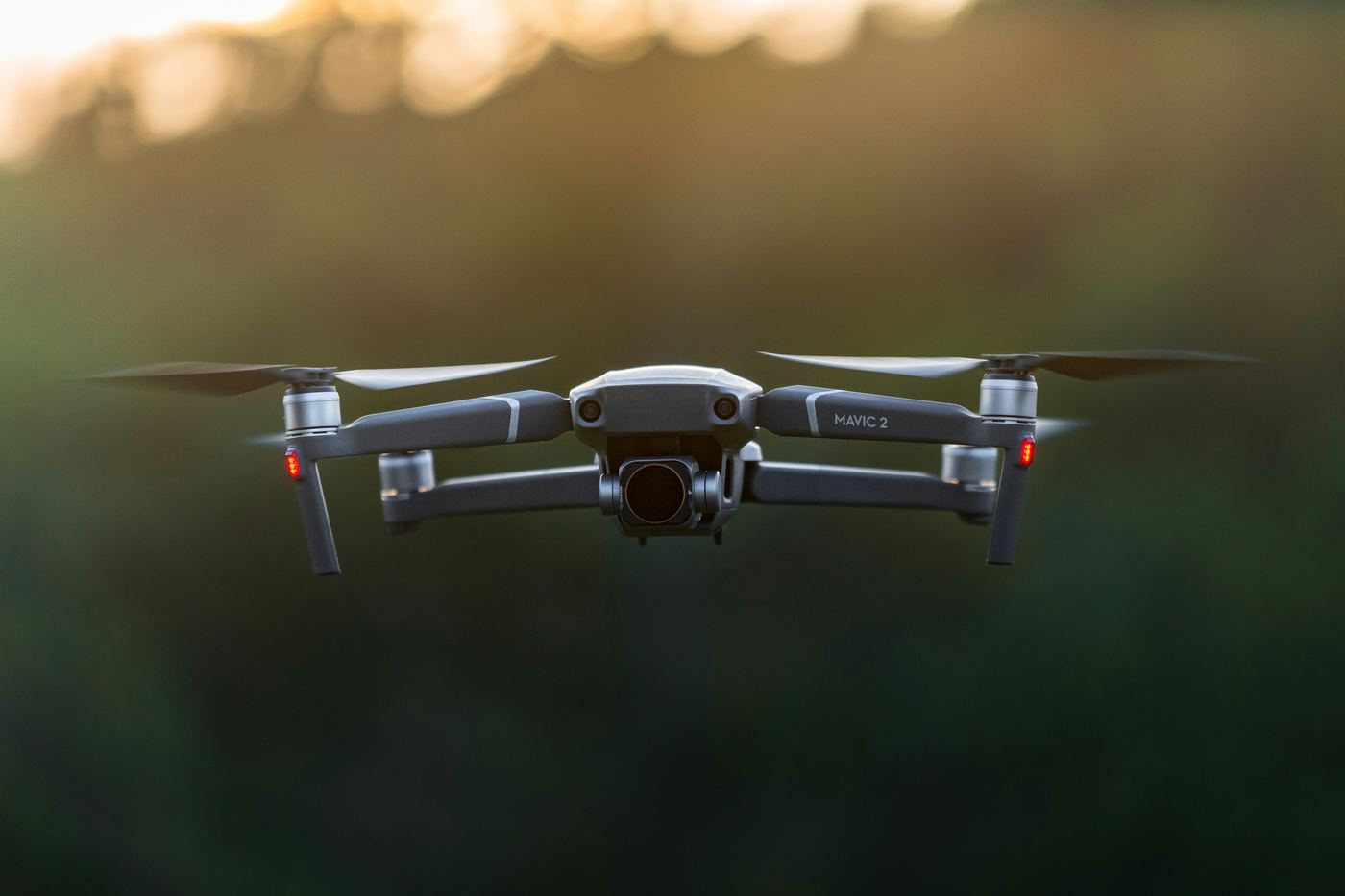 A drone in flight against a clear sky, moments after launch
